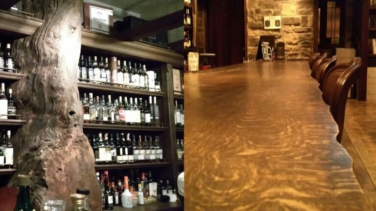 A split-composition image showing a well-lit bar shelf lined with whisky bottles framed by a Mizunara tree branch on the left, and a long solid wood bar counter on the right.